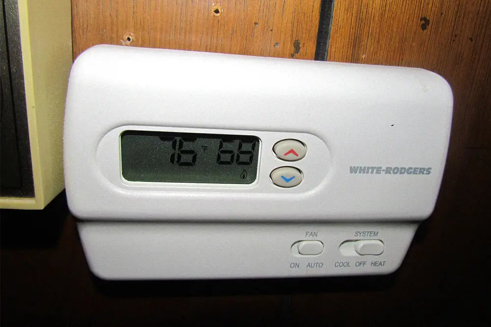 Wall-mounted thermometer used to monitor home air-conditioning performance